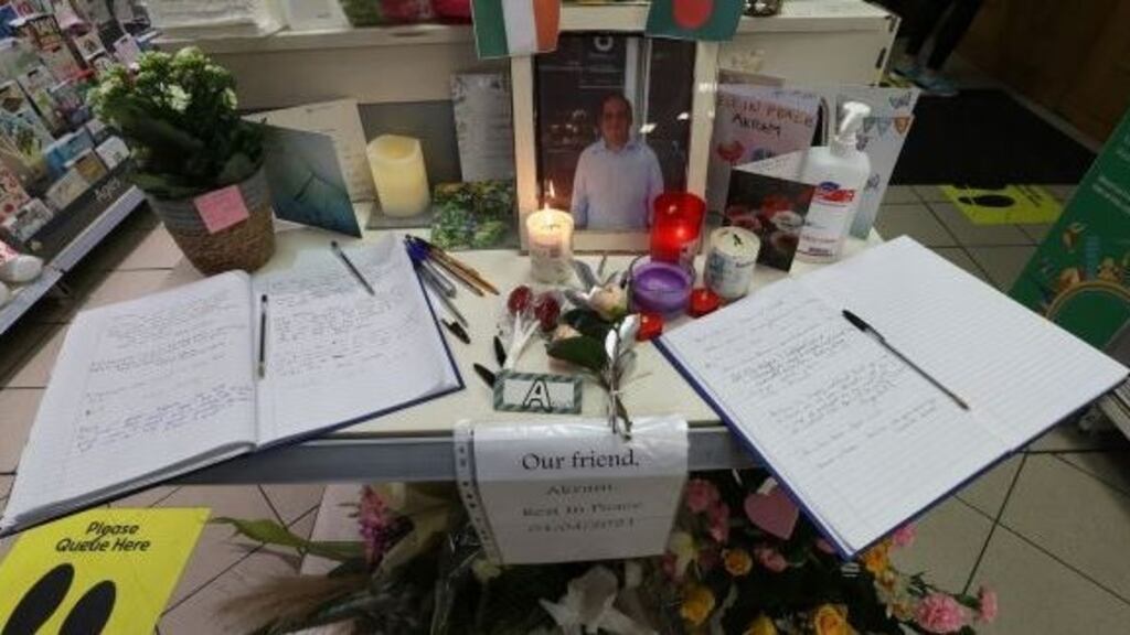 The local community write tributes to Akram Hussein in a book of condolences in the shop where he worked. Photograph: Nick Bradshaw