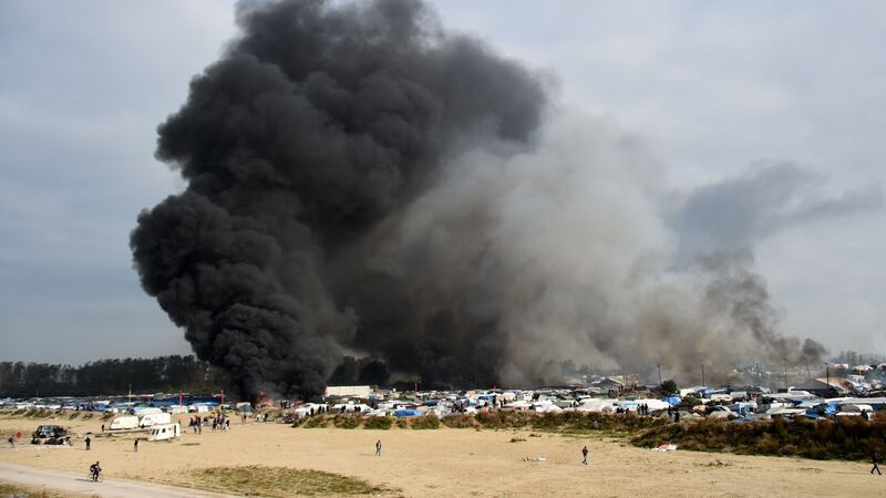 Smoke rises from fires at the ‘Jungle’ migrant camp in Calais, northern France, on October 26th, 2016. Photograph: Denis Charlet/AFP/Getty Images