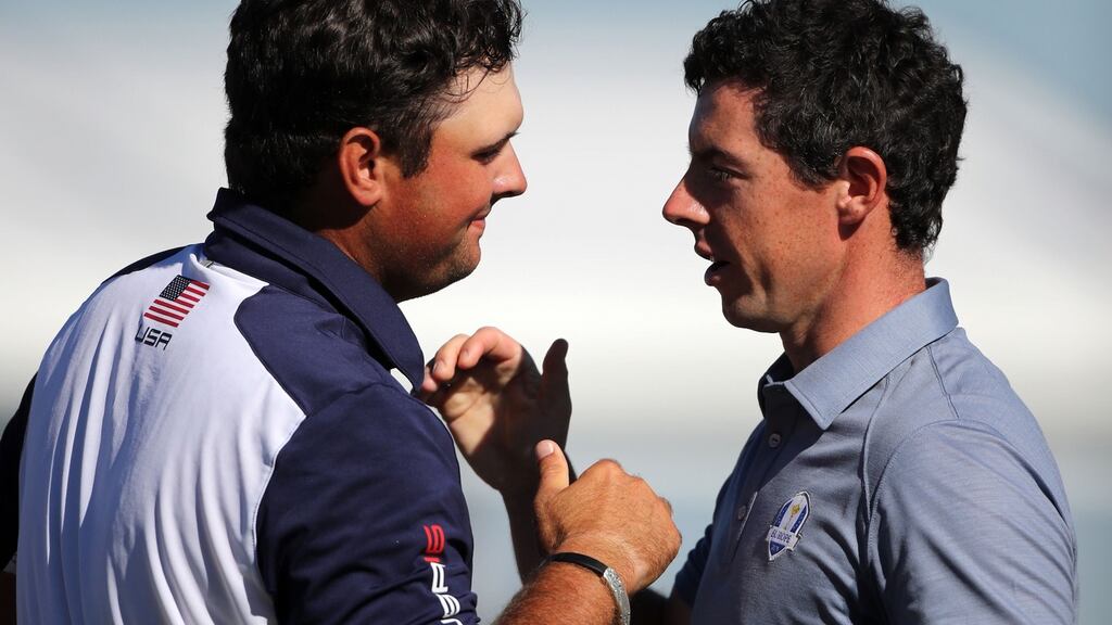 USA’s Patrick Reed and Europe’s Rory McIlroy shake hands after their singles match.  Photograph: Peter Byrne/PA Wire