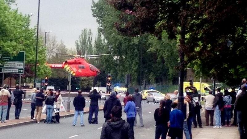 A police forensics officer investigates a crime scene where one man was killed in Woolwich, southeast London.