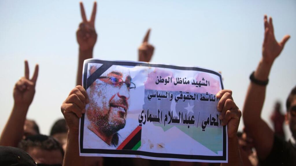 Men hold up a picture of slain lawyer and prominent Libyan political activist Abdelsalam al-Mosmary, during his funeral in Benghazi. Hundreds took to the streets overnight to denounce the killing of of Mr Abdelsalam al-Mosmary, who was shot dead on Friday after leaving a mosque. The words read, “Martyr, activist, homeland political and human rights activist Abdul Salam Al Mosmari”. Photograph: Esam Al-Fetori/Reuters