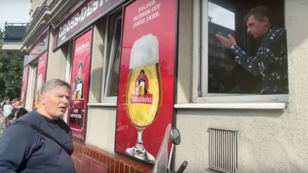 From the window of the Zur Quelle bar, a regular in a broad Berliner accent, began a debate with one passerby’s claims that the Covid-19 pandemic was a ‘big pharma takeover’ in a clip that went viral.