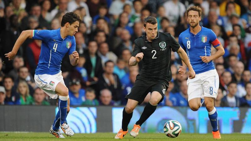 Ireland’s Séamus Coleman (centre) is watched by Italy’s Mattia De Sciglio (left) at Craven Cottage. Photograph: Nigel French/PA Wire