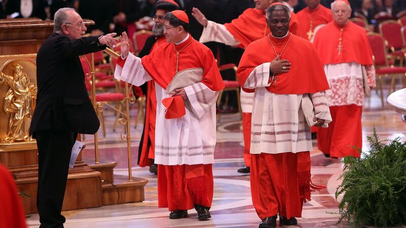Archbisop of Manila cardinal Luis Antonio Tagle (C) and Ghanian Cardinal Peter Appiah Turkson (R) attend the Pro Eligendo Romano Pontifice Mass at St Peter's Basilica. Photograph: Franco Origlia/Getty Images