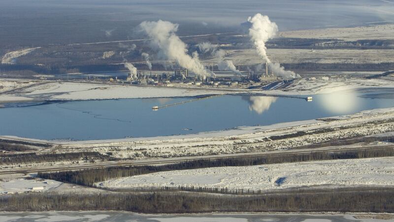 Syncrude and Suncor mines in Canada; one of Syncrude’s tailings ponds, with oil remains floating on it, is in the foreground. Photogaph: Veronique de Viguerie/Getty