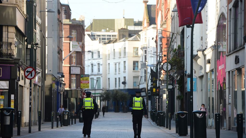 Gardaí on Grafton Street, Dublin during Covid-19 lockdown. Photograph: Dara Mac Dónaill / The Irish Times