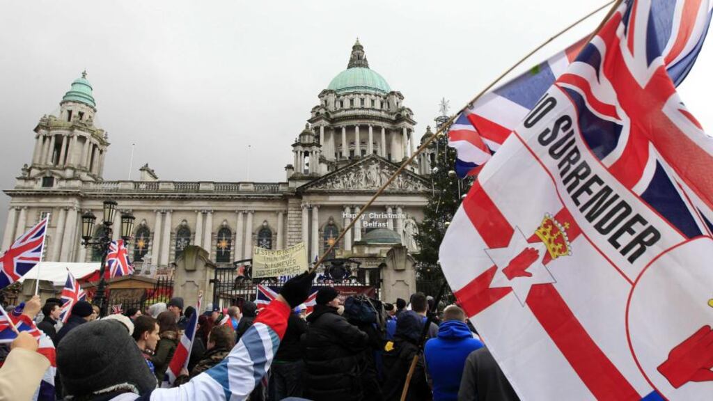 Union flags being waved in front of Belfast’s City Hall last December during protests over the decision by Belfast City Council to limit the number of days the flag is flown from the building. Photograph: Cathal McNaughton/Reuters