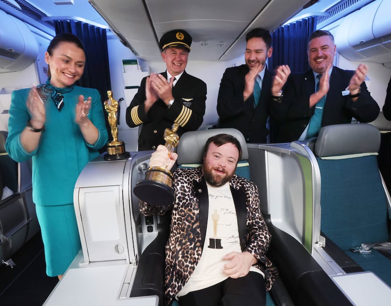 James Martin from An Irish Goodbye proudly clutching his Oscar with members of the Aer Lingus cabin crew who flew him home from Los Angeles. Photograph: Leon Farrell / Photocall Ireland