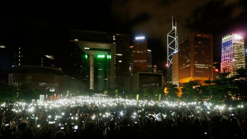 Pro-democracy protesters hold up their mobile phones during a campaign to kick off the Occupy Central civil disobedience event in front of the financial Central district in Hong Kong yesterday. Photograph: Reuters/Bobby Yip
