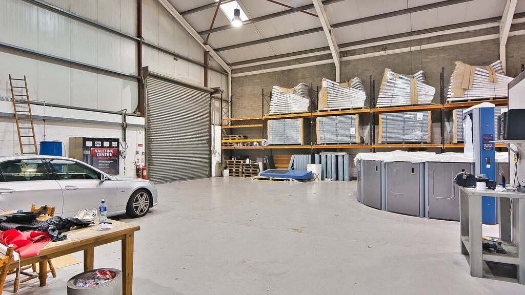 The property’s warehouse section has high eaves and roller shutter doors to the front and rear