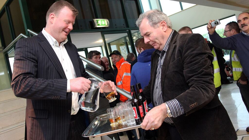 John McCartin and Sean Quinn enjoy a drink as Quinn returns to his HQ on Tuesday morning. Photograph: Lorraine Teevan.