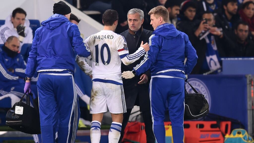 Chelsea manager José Mourinho speaks with Eden Hazard as he receives medical treatment during the Premier League match at the King Power Stadium. Photograph: Michael Regan/Getty Images