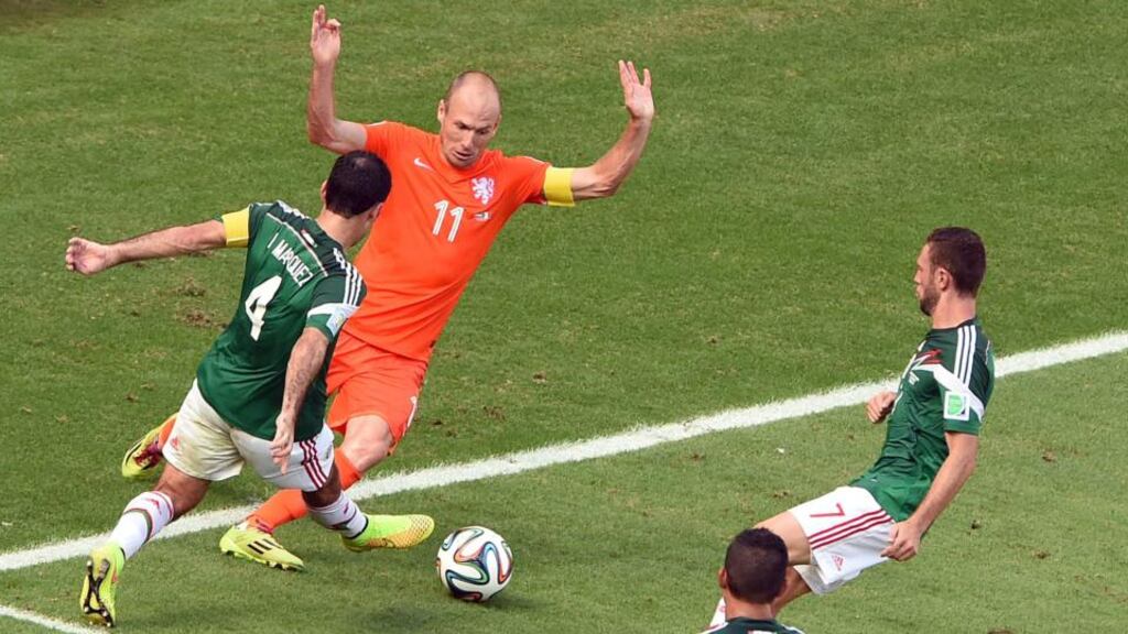 Arjen Robben of the Netherlands (C) is fouled by Rafael Marquez of Mexico at the Estadio Castelao in Fortaleza. Photograph: EPA