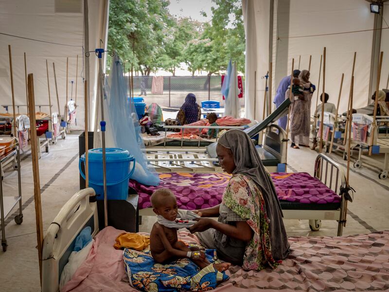 Dahabaya Ibet puts a shirt on her gaunt 20-month-old son, Moaid Salah, at a malnutrition center run by Doctors Without Borders in Adre, Chad. Photograph: Ivor Prickett/New York Times