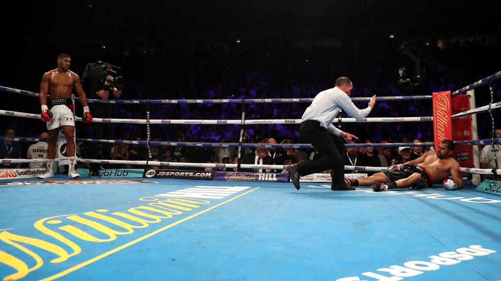 Anthony Joshua stands back as Eric Molina receives a count from referee Steve Gray during their IBF World Heavyweight Championship bout at the Manchester Arena. Photograph: Peter Byrne/PA Wire