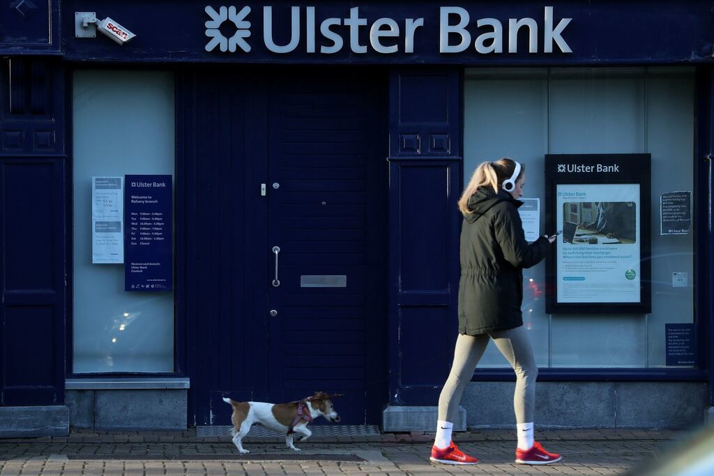 A woman and a dog pass an Ulster Bank branch in Raheny, Dublin. The withdrawal of Ulster Bank from the Irish market would be a “major hammer blow” to customers and workers, the Dail has heard. Picture date: Thursday February 18, 2021. PA Photo. See PA story IRISH UlsterBank. Photo credit should read: Brian Lawless/PA Wire