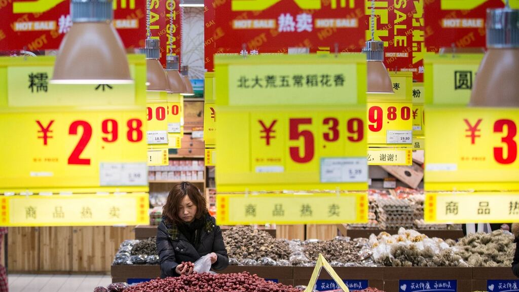 A woman shops in a supermarket in Hangzhou. The IMF has said a steeper slowing of demand in China remains a risk to global growth