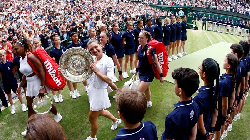 Simona Halep of Romania celebrates with the trophy after beating Williams in 56 minutes. Photograph: EPA