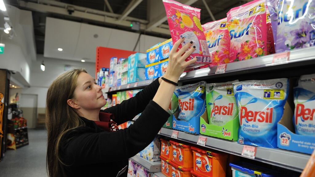Laura Hunt stacking packs of washing powder made by Unilever in Supervalu in Blackrock, Co Dublin. Unilever, Britain’s third-biggest company, will scrap its London corporate headquarters and make Rotterdam its sole legal home. Photograph: Aidan Crawley