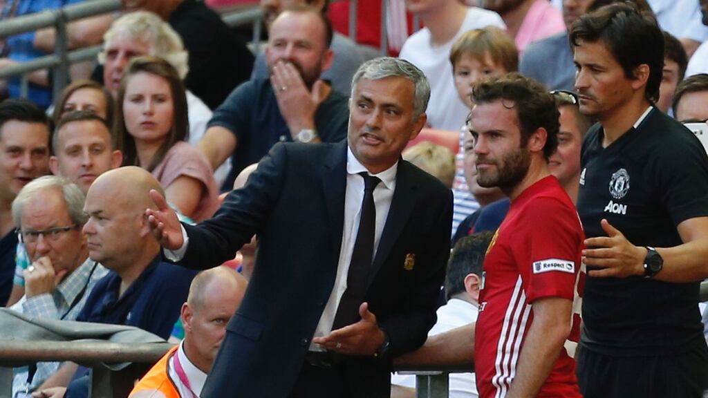 Manchester United manager Jose Mourinho explains to Juan Mata why he was taking him off in stoppage time after he came on as a substitute in the Community Shield win over Leicester City at Wembley. Photograph: Ian Kington/AFP/Getty Images