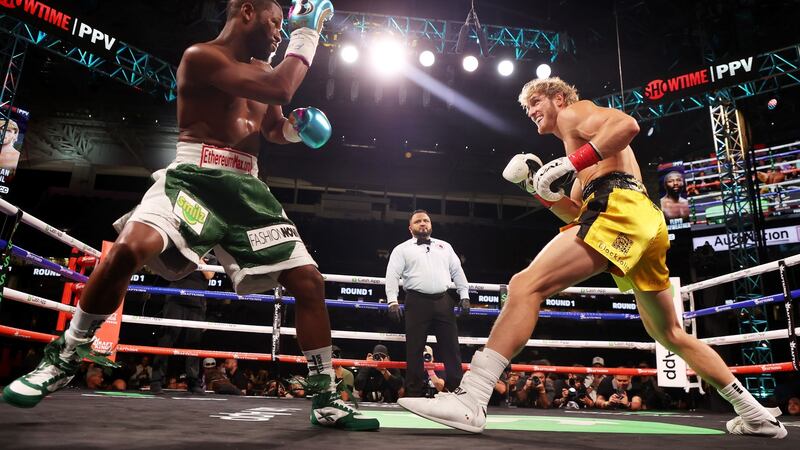 Floyd Mayweather exchanges blows with Logan Paul during their boxing exhibition match. That fame easily trumps sporting excellence is bad news for professional boxing, but good news for international football tournaments. Photograph: Cliff Hawkins/Getty Images