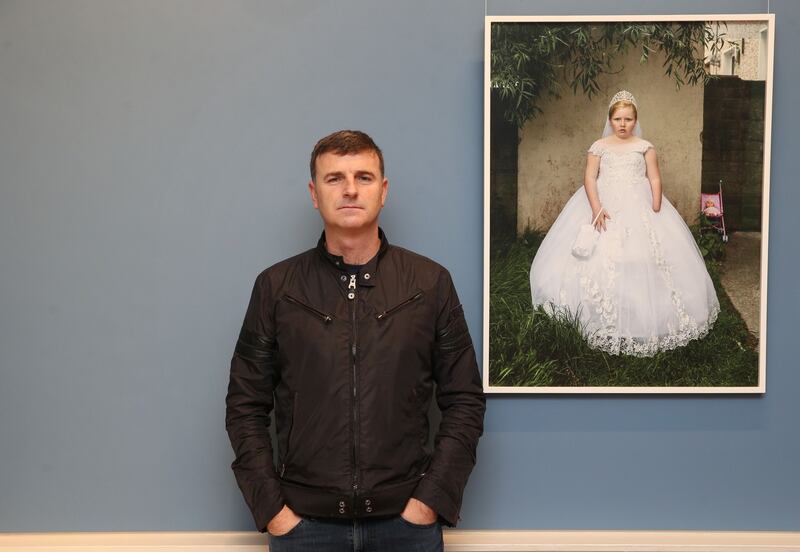 Kenneth O Halloran beside his portrait entitled Winnie Lawrence at the National Gallery of Ireland as part of the Hennessy Portrait Prize. Photograph: Leon Farrell/Photocall Ireland.