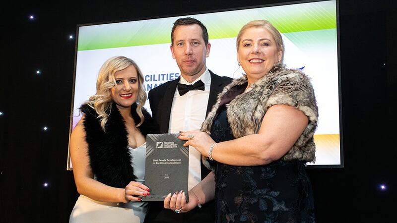 Aine Mulcahy, Managing Director, OCS Group Ireland presents the Best People Development in Facilities Management award to Alana Wilksch & Alan Sweeney, CBRE.