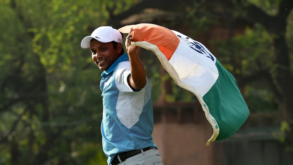 SSP Chawrasia celebrates with the Indian national flag following his victory in the Hero Indian Open at Delhi Golf Club. Photograph: Stuart Franklin/Getty Images
