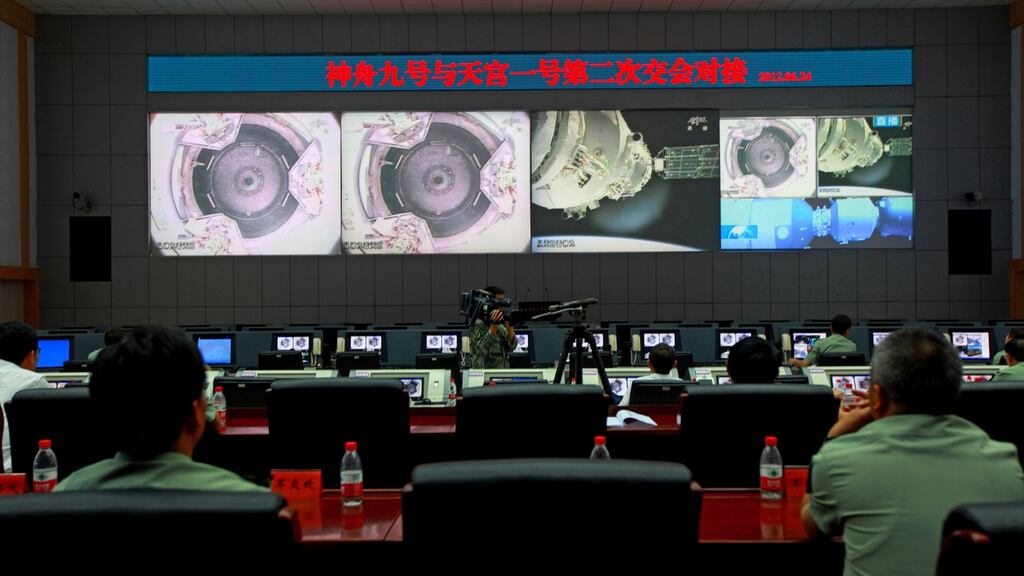 Chinese technicians at the Jiuquan Space Centre monitor the Shenzhou-9 spacecraft as it prepares to link with the Tiangong-1 module on June 24, 2012. Photograph: AFP/Getty Images