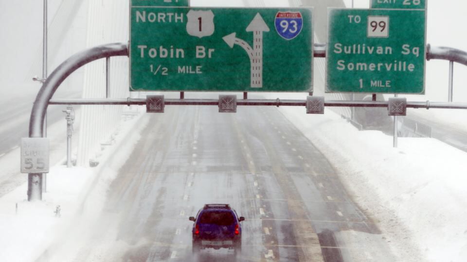 A lone car drives over the Zakim Bridge in Boston. Photograph: AP