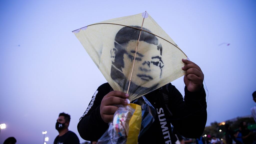 A protester holds a kite with an image of pro-democracy activist Parit ‘Penguin’ Chiwarak during a demonstration near the Grand Palace in Bangkok in March. Photograph: Varuth Pongsapipatt/SOPA Images/LightRocket via Getty Images