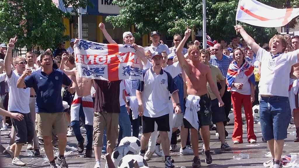 England fans make their presence felt in Charleroi during Euro 2000. Ranks of riot police used water cannons in an effort to prevent fighting between England and German fans massed on opposite sides of the main Charles II square into side streets. Photo: Philip Huguen/Getty Images