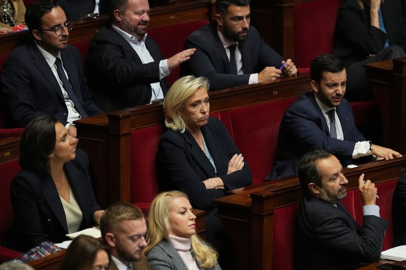 French far-right leader Marine Le Pen, centre, listens to debates before a no-confidence vote at the National Assembly in Paris. Photograph: Thibault Camus/AP