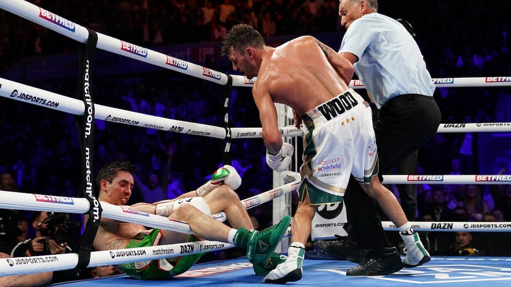 Michael Conlan falls out of the ring after being knocked out by Leigh Wood in their WBA Featherweight World Title contest at the Motorpoint Arena in Nottingham. Photograph: Zac Goodwin/PA Wire