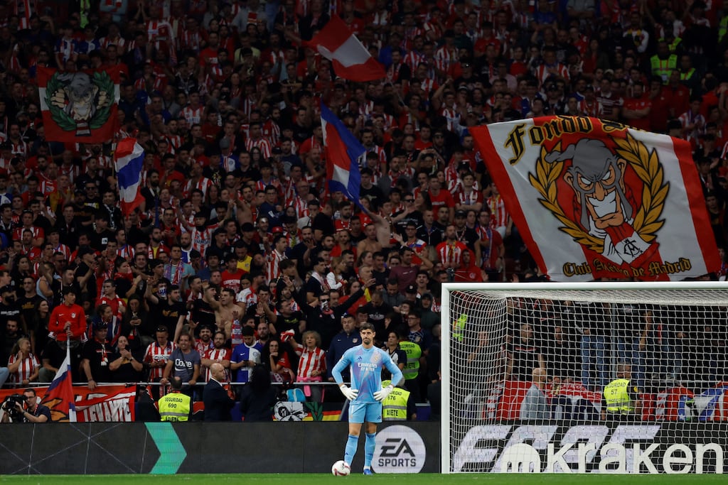 Real Madrid goalkeeper Thibaut Courtois waits after Atlético Madrid's supporters threw items on to the pitch during the derby game at the Metropolitano stadium in Madrid. Photograph: Oscar Del Pozo/AFP via Getty Images