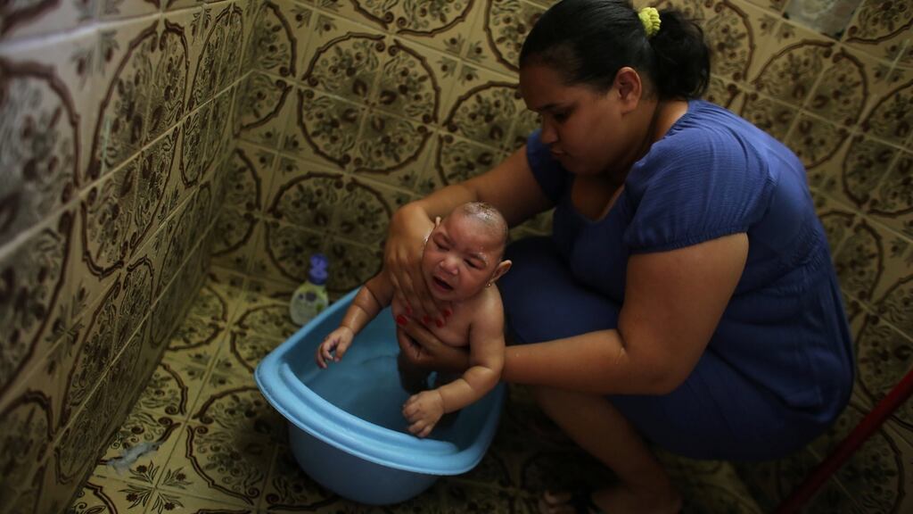 Jaqueline bathes her five-month-old daughter Laura - who suffers from microcephaly, a birth defect associated with the Zika virus, at their house in Santos, Sao Paulo state, Brazil. Photograph: Nacho Doce/Reuters