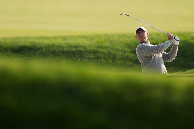Rory McIlroy of Northern Ireland plays a shot from the bunker on the fourth hole during a practice round. Photograph: Patrick Smith/Getty