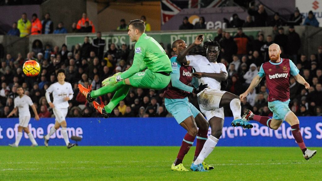 West Ham’s Adrian in action with Swansea’s Bafetimbi Gomis. Photograph: Rebecca Naden/Reuters