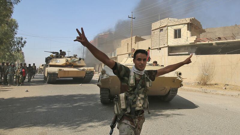 An Iraqi forces fighter celebrates as government forces vehicles move through Tal Afar.  Photograph: Ahmad Al-Rubaye/AFP/Getty Images