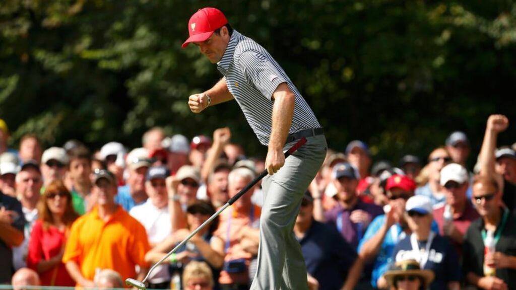 US team member Keegan Bradley celebrates his birdie putt on the second hole as he and team-mate Phil Mickelson play the international team of Jason Day, of Australia, and Graham DeLaet, of Canada, during their Presidents Cup foursome match at Muirfield Village. Photograph: Chris Keane/Reuters