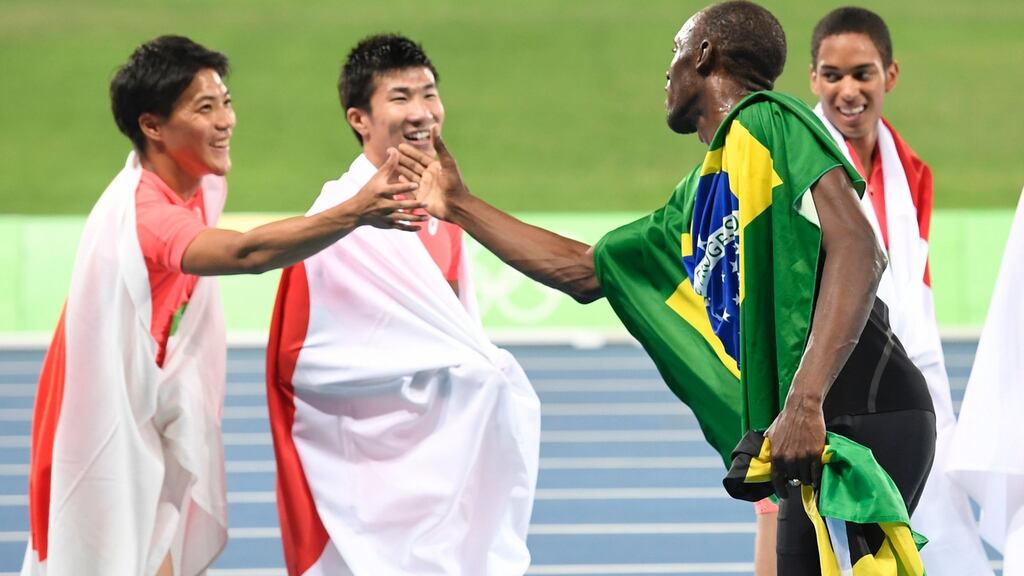 Jamaica’s Usain Bolt congratulates team Japan at the end of the Men’s 4x100m relay final. Photograph: Getty Images