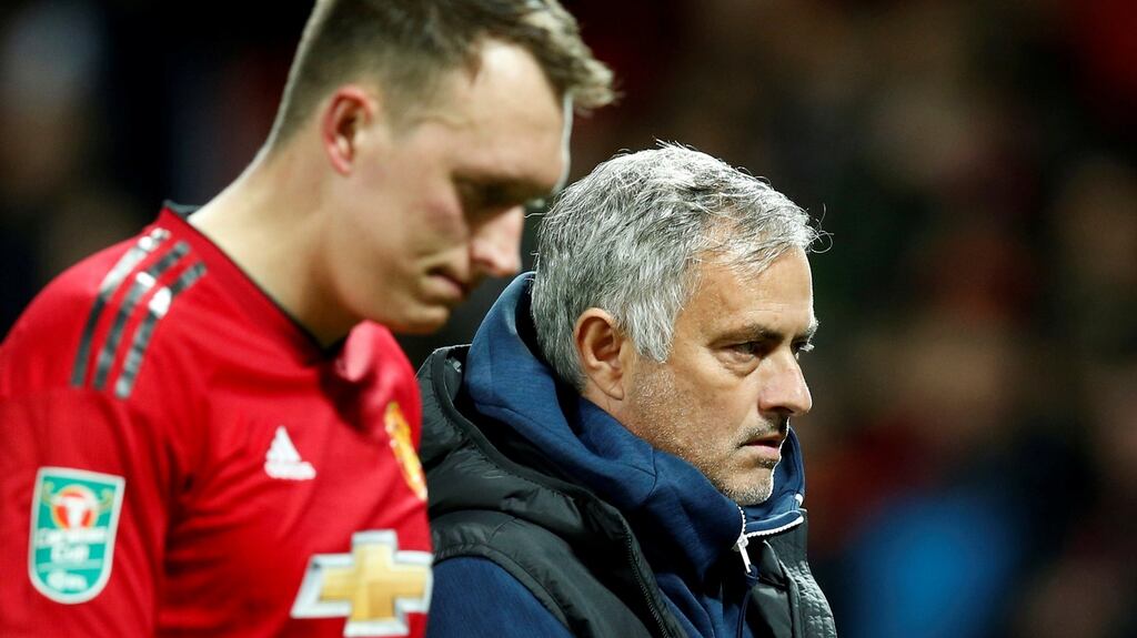 Manchester United’s Phil Jones and Jose Mourinho leave the pitch after losing to Derby County at Old Trafford. Photograph: Reuters