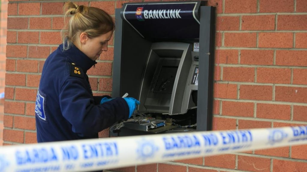 A member of the Garda examines criminal damage made to an ATM at Knocklyon Shopping Centre, Dublin. Photo: Gareth Chaney/Collins