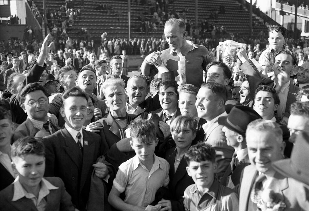Christy Ring being carried off the pitch on the shoulders of spectators after the 1953 All-Ireland hurling final in Croke Park
