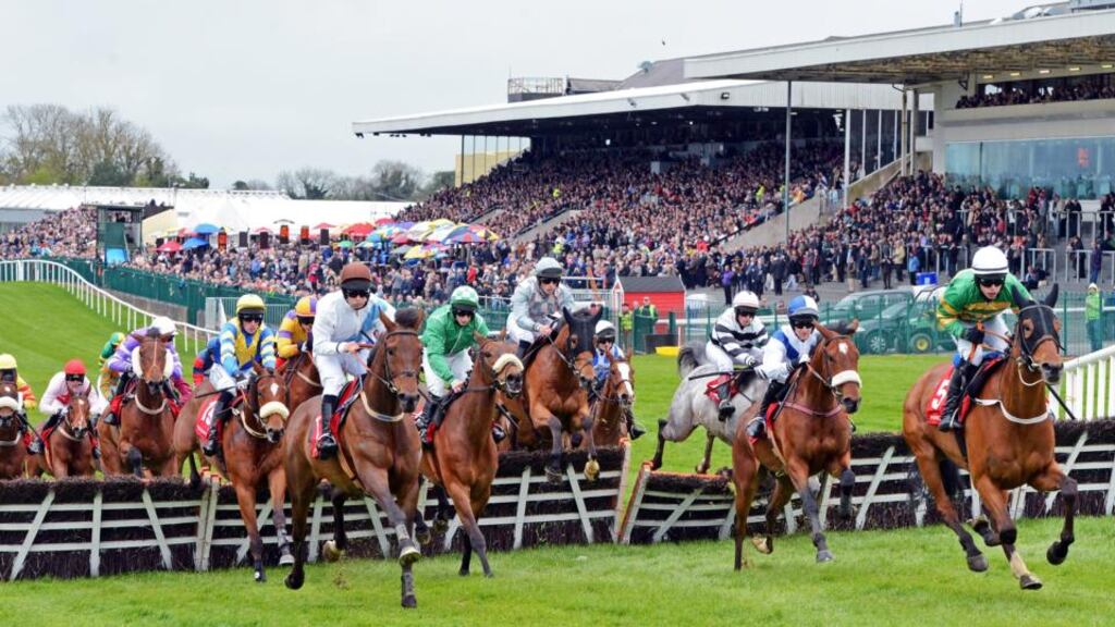 Runners and riders take the first hurdle, with the packed stand in the background, in The Martinstown Opportunity Series Final Handicap Hurdle, on the second day of The Punchestown Festival. Photograph: Eric Luke/The Irish Times