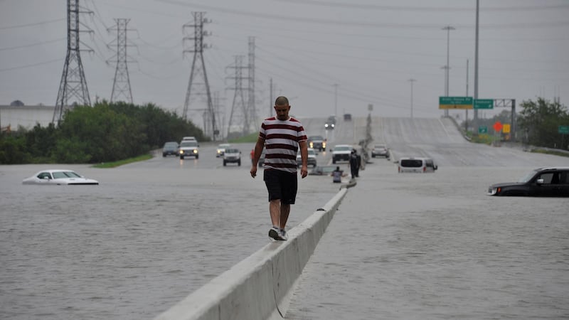 A stranded motorist escapes floodwaters in Texas on Sunday. Photograph: Nick Oxford/Reuters
