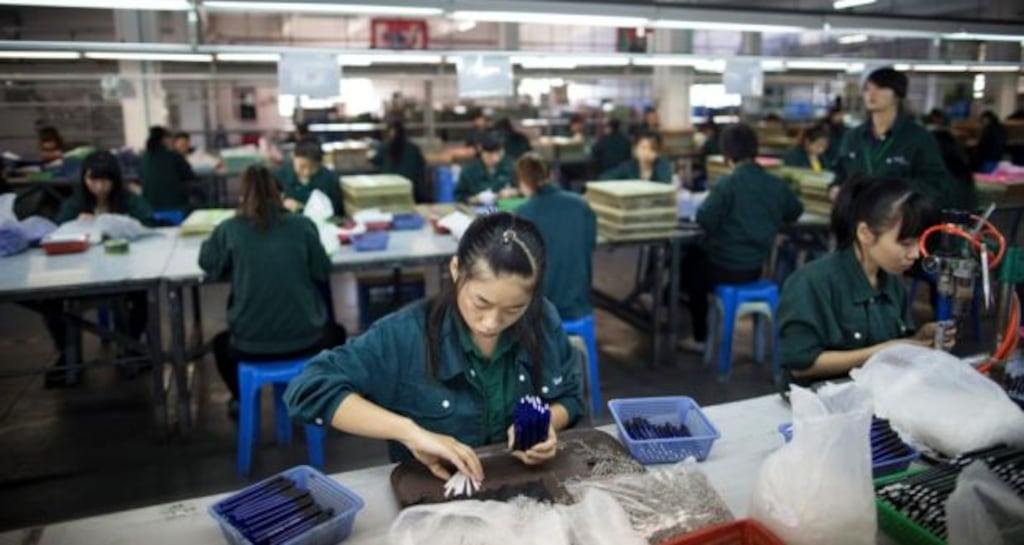 Workers assemble pens at the A.W. Faber-Castell (Guangzhou) Stationery Co. factory in Guangzhou, Guangdong province, China. Photographer: Brent Lewin/Bloomberg