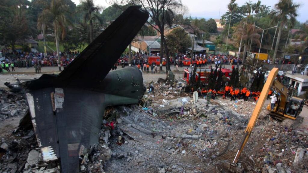 Indonesian rescuers and military personnels examine the wreckage of the crashed C-130 military airplane at the crash site in Medan, North Sumatra, Indonesia. Photograph: Dedi Sahputra/EPA