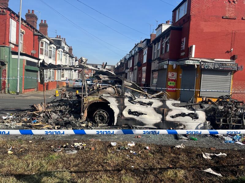 A burnt out car in the Leeds suburb of Harehills following an outbreak of disorder on Thursday evening. Photograph: Katie Dickinson/PA Wire