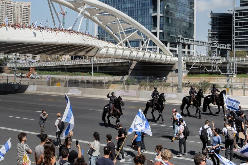 Mounted police moving in on protesters blocking a highway in Tel Aviv. Photograph: Amit Elkayam/The New York Times